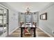 Cozy dining room featuring natural light, stylish chandelier, and wood flooring at 4072 Everett Ave, Spring Hill, FL 34609