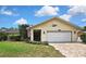 Charming single-story home with a brick driveway, American flag, and well-maintained landscaping at 4072 Everett Ave, Spring Hill, FL 34609