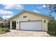 Close-up of a one-story home with a brick driveway, a two car garage and a covered front entry at 4072 Everett Ave, Spring Hill, FL 34609