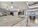 Bright kitchen features granite countertops, stainless appliances and an open floorplan at 4072 Everett Ave, Spring Hill, FL 34609