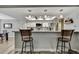 Bright kitchen features granite countertops, stainless appliances, breakfast bar and wood-look flooring at 4072 Everett Ave, Spring Hill, FL 34609