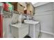 Functional laundry room featuring a utility sink, a washer and dryer, and open shelving for storage at 4072 Everett Ave, Spring Hill, FL 34609