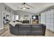 Spacious living room features an open concept, gray walls, hardwood flooring and a leather sectional at 4072 Everett Ave, Spring Hill, FL 34609