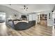 Spacious living room features an open concept, gray walls, hardwood flooring and a leather sectional at 4072 Everett Ave, Spring Hill, FL 34609