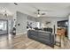 Spacious living room features an open concept, gray walls, hardwood flooring and a leather sectional at 4072 Everett Ave, Spring Hill, FL 34609