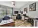 Home office with hardwood floors, a ceiling fan, a black leather chair, a sofa and a desk at 4072 Everett Ave, Spring Hill, FL 34609