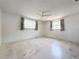 Cozy bedroom with ceiling fan and two windows offering natural light at 4142 Crestfield Ave, Holiday, FL 34691