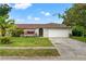Charming single-story home with a well-manicured front yard and attached two car garage at 4350 Sawgrass Blvd, New Port Richey, FL 34653