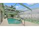 Inviting screened-in pool area with a relaxing atmosphere and decorative accents, perfect for leisure and entertainment at 4350 Sawgrass Blvd, New Port Richey, FL 34653