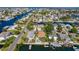 Scenic aerial view of a waterfront community with canals, docks, and lush greenery surrounding the homes at 4460 Flounder Dr, Hernando Beach, FL 34607