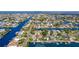 Panoramic aerial showcasing waterfront homes along canals, with Gulf of Mexico access and lush landscaping at 4460 Flounder Dr, Hernando Beach, FL 34607