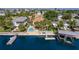 Aerial view of a waterfront home with a pool, dock, and boat lift; perfect for enjoying the coastal lifestyle at 4460 Flounder Dr, Hernando Beach, FL 34607