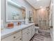 Bright bathroom featuring a walk-in shower, white cabinets, and modern fixtures at 4460 Flounder Dr, Hernando Beach, FL 34607