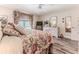 Serene bedroom with floral bedding, wicker furniture, and garden views, offering a peaceful retreat at 4460 Flounder Dr, Hernando Beach, FL 34607