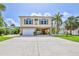Charming two-story coastal home with a garage, carport, and landscaped front yard at 4460 Flounder Dr, Hernando Beach, FL 34607