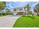 Charming two-story coastal home with a garage, carport, and landscaped front yard at 4460 Flounder Dr, Hernando Beach, FL 34607
