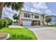Charming two-story coastal home with a garage, carport, and landscaped front yard at 4460 Flounder Dr, Hernando Beach, FL 34607