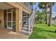 Side view of a tan home with a screened lanai and stairway to an upper-level balcony at 4460 Flounder Dr, Hernando Beach, FL 34607
