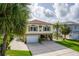 Charming coastal home showcasing lush landscaping, a spacious driveway, and ground-level patio area for outdoor enjoyment at 4460 Flounder Dr, Hernando Beach, FL 34607