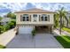 Inviting home featuring a wide driveway, two-car garage, and charming decorative details at 4460 Flounder Dr, Hernando Beach, FL 34607
