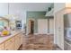 Spacious kitchen flows to other rooms with wood cabinets and stainless steel appliances at 4460 Flounder Dr, Hernando Beach, FL 34607