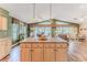 Open-concept kitchen with a large island, wood cabinets, and easy access to living area at 4460 Flounder Dr, Hernando Beach, FL 34607