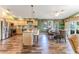 Spacious kitchen with stainless steel appliances, island with granite countertop, and eat-in dining area at 4460 Flounder Dr, Hernando Beach, FL 34607