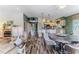 Open-concept living space boasts wood-look floors, ample seating, and a breakfast bar at 4460 Flounder Dr, Hernando Beach, FL 34607