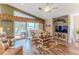 Comfortable living room with outdoor access, entertainment center, and ceiling fan at 4460 Flounder Dr, Hernando Beach, FL 34607