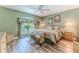 Cozy main bedroom featuring a large window, wood flooring, and comfortable furnishings at 4460 Flounder Dr, Hernando Beach, FL 34607