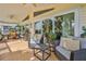 Relaxing covered outdoor patio with comfortable seating and a view of the lush tropical landscaping at 4460 Flounder Dr, Hernando Beach, FL 34607
