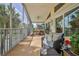 Comfortable seating and a grill furnish a screened patio with lush greenery outside the lanai at 4460 Flounder Dr, Hernando Beach, FL 34607