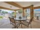 Covered patio with outdoor dining table and chairs, offering views of the backyard, pool, and canal at 4460 Flounder Dr, Hernando Beach, FL 34607