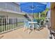 Outdoor patio offers a cozy seating area with a table, chairs, and umbrella perfect for waterfront relaxation and entertaining at 4460 Flounder Dr, Hernando Beach, FL 34607