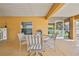 Outdoor patio features a dining table, tile floors, and access to a screened lanai and stairs at 4460 Flounder Dr, Hernando Beach, FL 34607