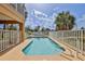 Inviting backyard pool surrounded by a white fence with a beautiful sky at 4460 Flounder Dr, Hernando Beach, FL 34607