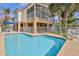 Pool with outdoor seating and a screened-in porch, offering a blend of indoor-outdoor living and waterfront charm at 4460 Flounder Dr, Hernando Beach, FL 34607