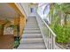 Exterior staircase with white railing and landscaping leading to the main living area at 4460 Flounder Dr, Hernando Beach, FL 34607