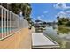 Waterfront view showing the pool, patio, and dock ideal for boats and outdoor enjoyment at 4460 Flounder Dr, Hernando Beach, FL 34607