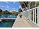 Tranquil waterfront view showing a bench, dock, and fenced property, offering serene outdoor relaxation at 4460 Flounder Dr, Hernando Beach, FL 34607