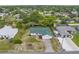 Charming single-story home with a green roof, attached garage, and a well-maintained front yard in a quiet neighborhood at 5035 Harbinger Rd, Spring Hill, FL 34608