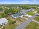 Charming home with a green roof, surrounded by lush greenery, a driveway, and well-maintained landscaping in a peaceful neighborhood at 5035 Harbinger Rd, Spring Hill, FL 34608