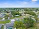 Residential neighborhood with tree-lined streets, showcasing a variety of homes and well-kept properties under a sunny sky at 5035 Harbinger Rd, Spring Hill, FL 34608