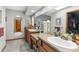 Dual sink bathroom with neutral decor, tile flooring, and wood cabinets at 5035 Harbinger Rd, Spring Hill, FL 34608
