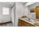 Neat bathroom features a large vanity, mirror, and shower with white tiles at 5035 Harbinger Rd, Spring Hill, FL 34608