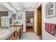 Bathroom featuring neutral decor, dual sinks, wood cabinets, and tile flooring at 5035 Harbinger Rd, Spring Hill, FL 34608