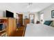 Spacious bedroom featuring a ceiling fan, wood floors, closet, and bright natural lighting at 5035 Harbinger Rd, Spring Hill, FL 34608