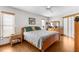 Bright main bedroom with neutral decor, two windows, ceiling fan, and wood flooring at 5035 Harbinger Rd, Spring Hill, FL 34608
