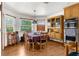 Inviting dining room with natural light, wood flooring, and natural wood cabinets with a built-in oven at 5035 Harbinger Rd, Spring Hill, FL 34608