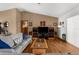 Cozy living room showing the sliding glass doors, media center, and vaulted ceilings at 5035 Harbinger Rd, Spring Hill, FL 34608